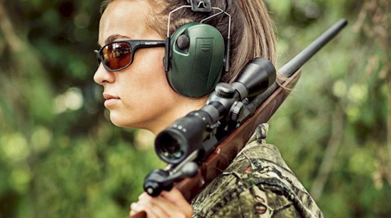 National Rifle Association of America women hunter wearing her eye and ear protection
